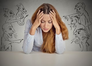 Evil Men pointing at stressed woman. Desperate young businesswoman sitting at desk in her office isolated on grey wall background. Negative human emotions face expression feelings life perception.jpeg