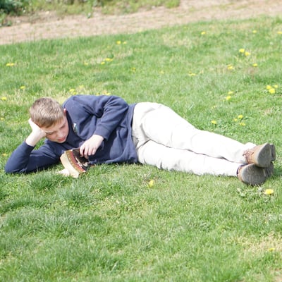 boy-reading-on-grass